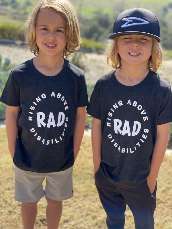 Two boys wearing black shirts with RAD camp logo