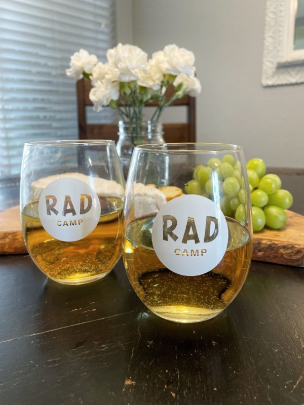 Image of stemless wine glasses with the RAD logo in white