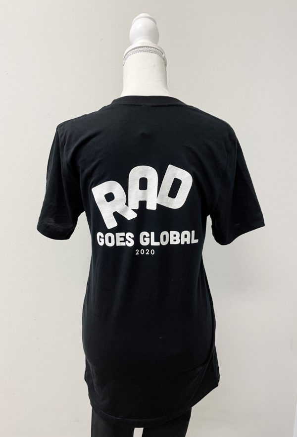 Image of the back of a black shirt on a mannequin with RAD in large letters, each letter is tilted. Underneath are the words GOES GLOBAL, and 2020 underneath that.