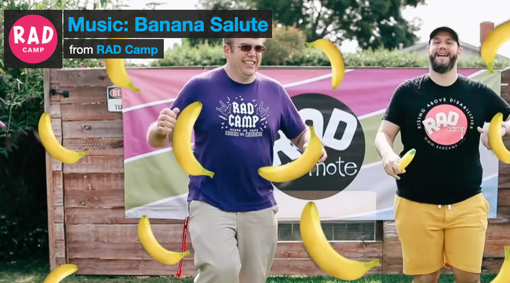 Image of 2 men smiling and dancing. There is a banana animation overlay. Text says "Music: Banana Salute"