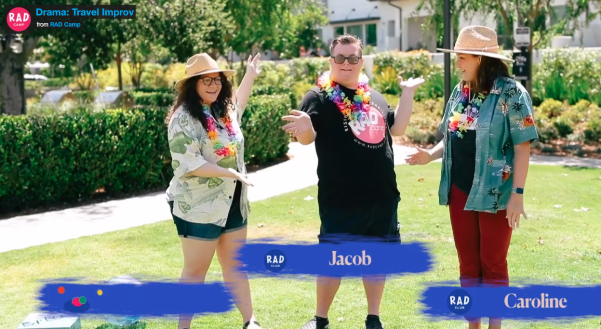 3 people wearing leis are smiling and posing as they play a game.