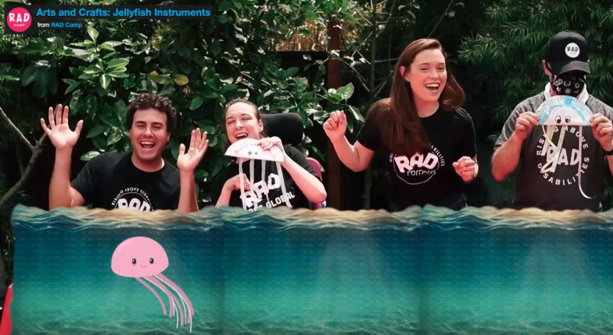 4 people smiling and laughing and holding up their Jellyfish shakers