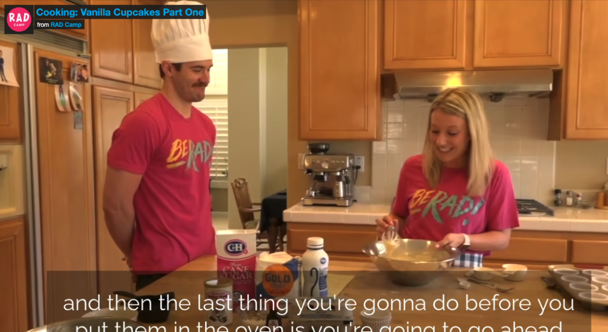 A man and woman baking cupcakes in a kitchen
