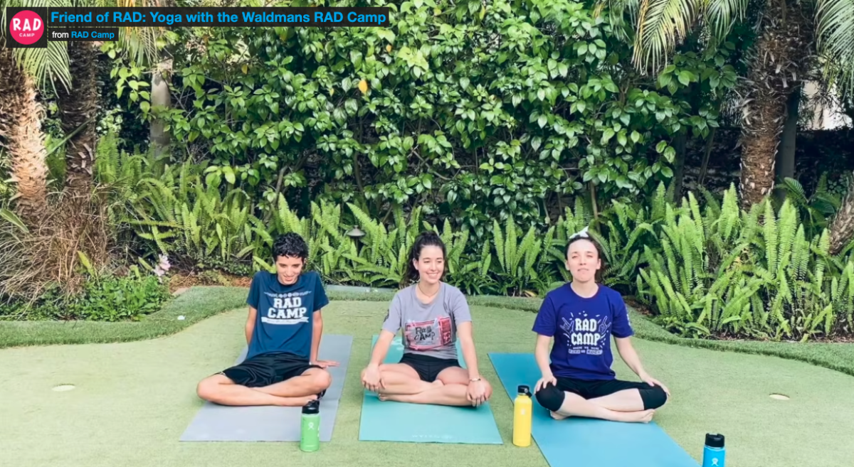 3 people sitting on yoga mats with their legs crossed