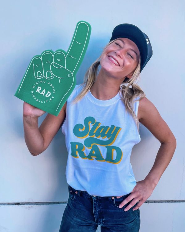 Girl wearing white tank with Stay RAD and black RAD hat